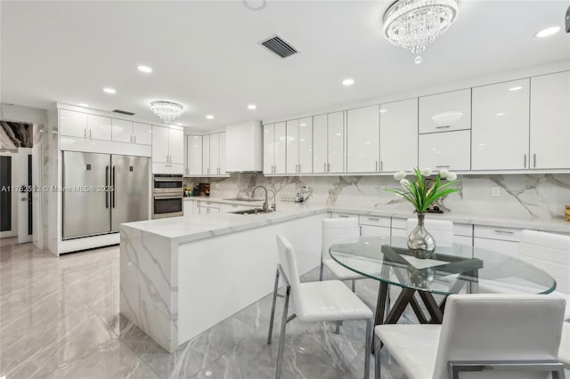 kitchen featuring modern cabinets, visible vents, white cabinetry, and stainless steel appliances