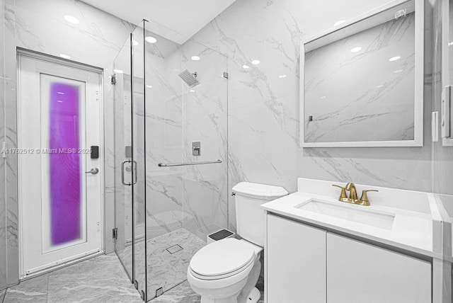 full bath with a marble finish shower, tile walls, toilet, marble finish floor, and vanity