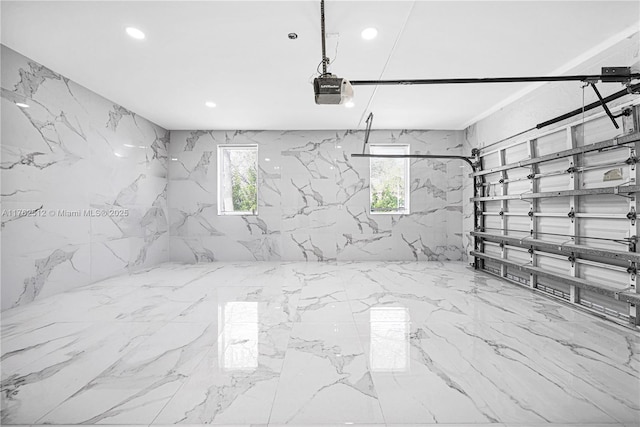 garage with recessed lighting and a garage door opener