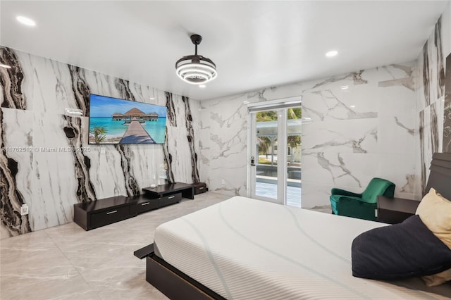 bedroom with recessed lighting, access to exterior, stone wall, and marble finish floor