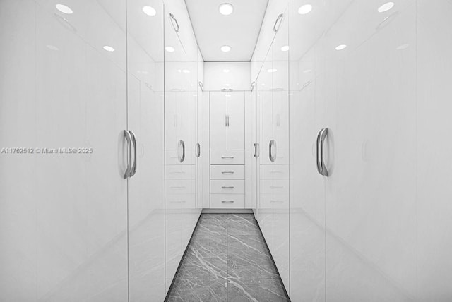 interior space featuring recessed lighting and marble finish floor