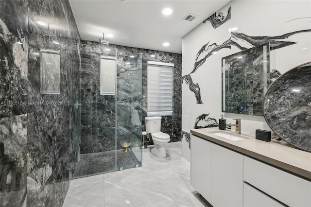 full bath with a tile shower, marble finish floor, toilet, vanity, and visible vents