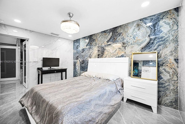 bedroom with stone wall, visible vents, marble finish floor, and recessed lighting