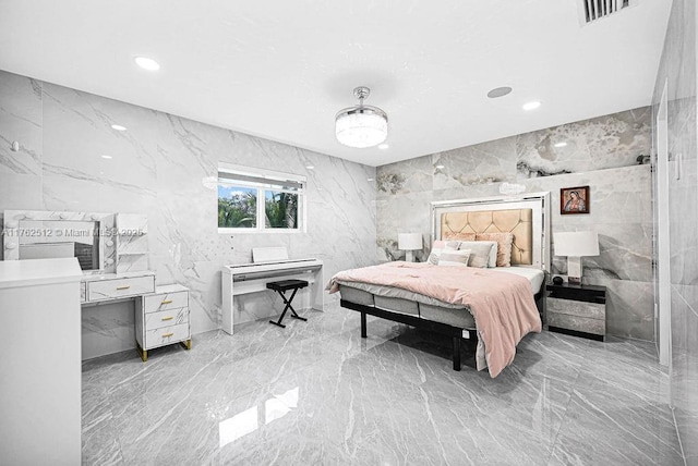 bedroom featuring visible vents, marble finish floor, recessed lighting, tile walls, and stone wall