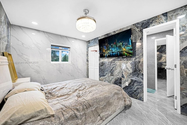 bedroom featuring tile walls, stone wall, recessed lighting, and marble finish floor