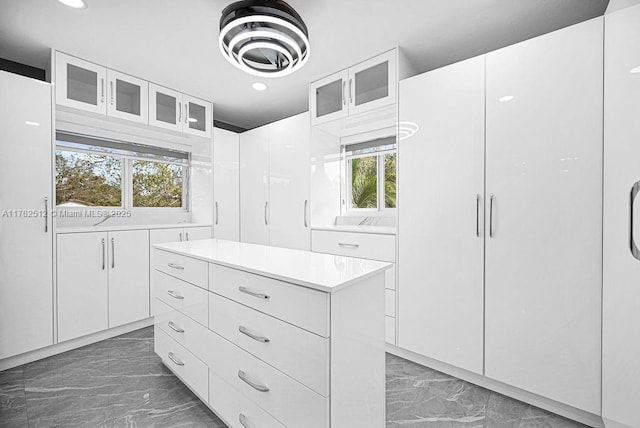 spacious closet featuring marble finish floor