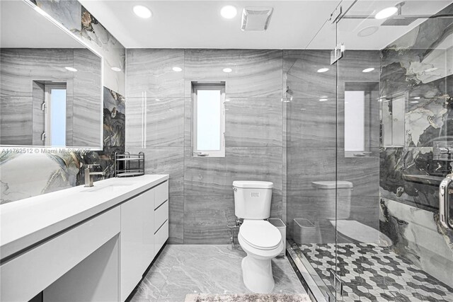 full bath with a stall shower, toilet, recessed lighting, vanity, and marble finish floor