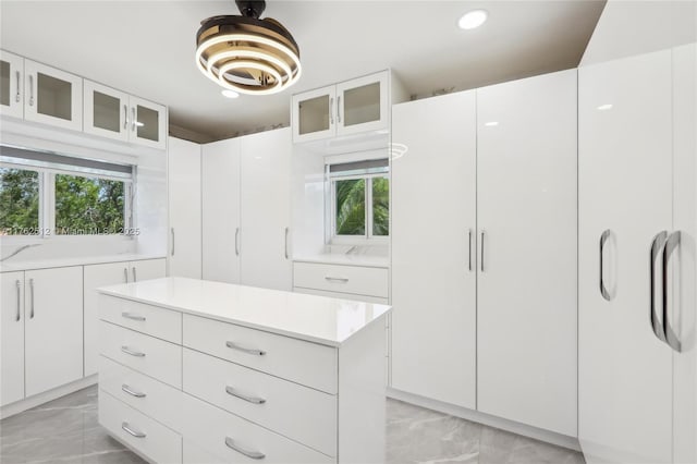 walk in closet with marble finish floor