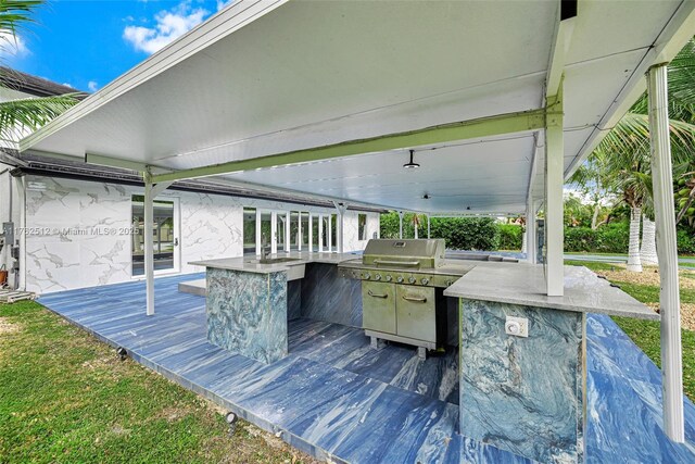 view of patio with a wooden deck, area for grilling, and outdoor wet bar