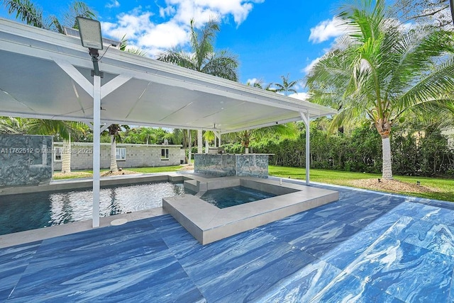 view of swimming pool with an in ground hot tub