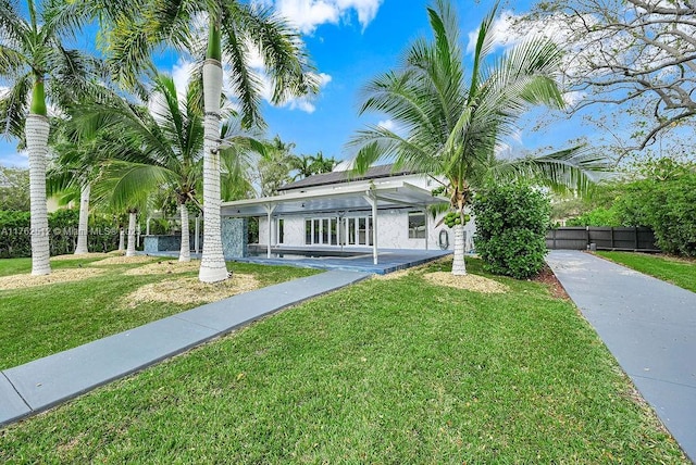 view of front of home featuring a front yard and fence