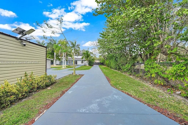 view of property's community featuring fence and a lawn