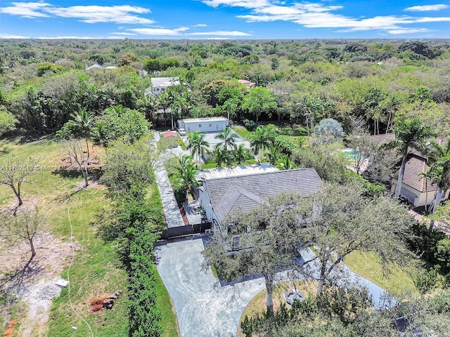 drone / aerial view with a wooded view