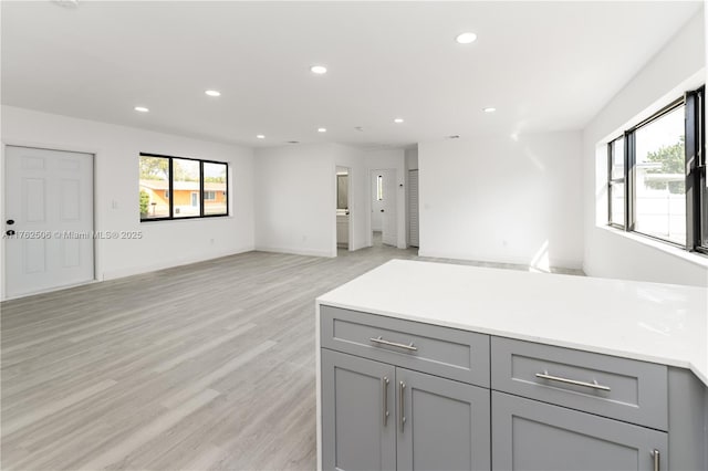 kitchen with recessed lighting, a healthy amount of sunlight, and gray cabinets