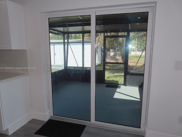 entryway featuring baseboards and wood finished floors