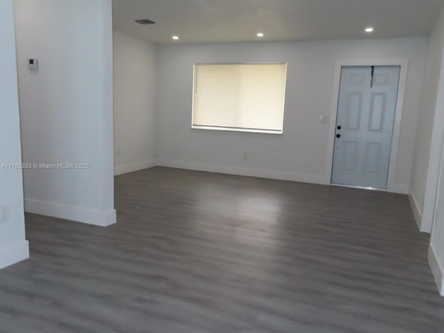 spare room featuring recessed lighting, visible vents, baseboards, and wood finished floors