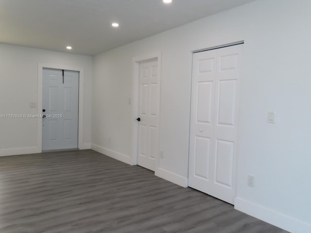 unfurnished room with recessed lighting, baseboards, and wood finished floors