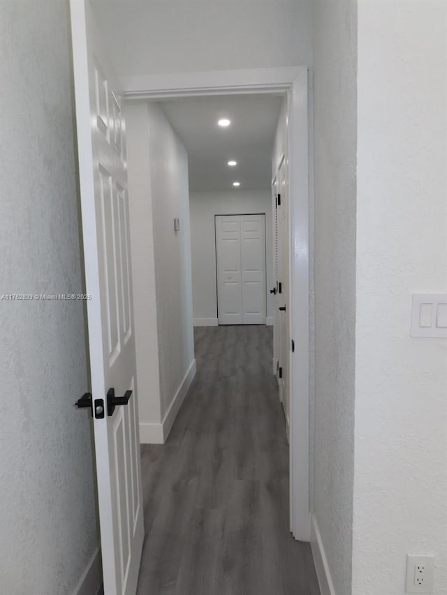 hall featuring recessed lighting, baseboards, and wood finished floors