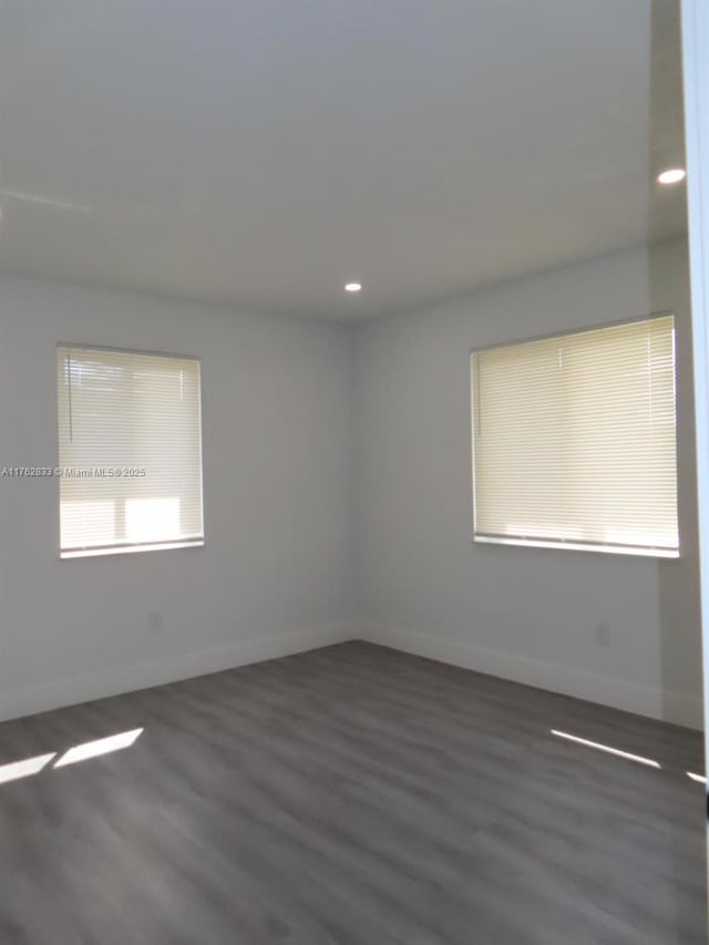 unfurnished room with recessed lighting, baseboards, and wood finished floors