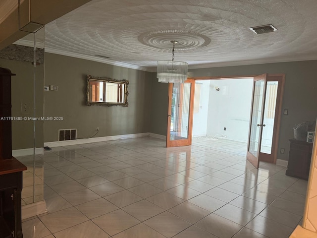 empty room with visible vents, french doors, and crown molding