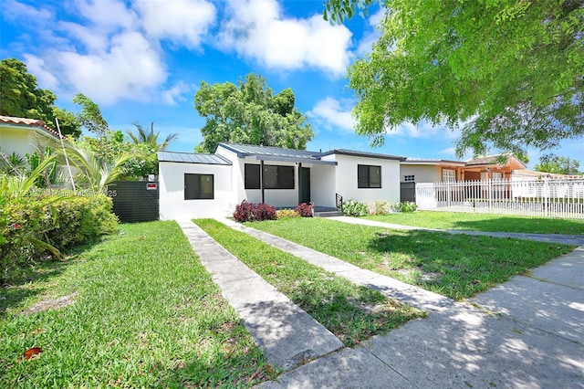 2261 SW 26th St, Miami, FL 33133 - view of front facade featuring stucco siding, a standing seam roof, and metal roof