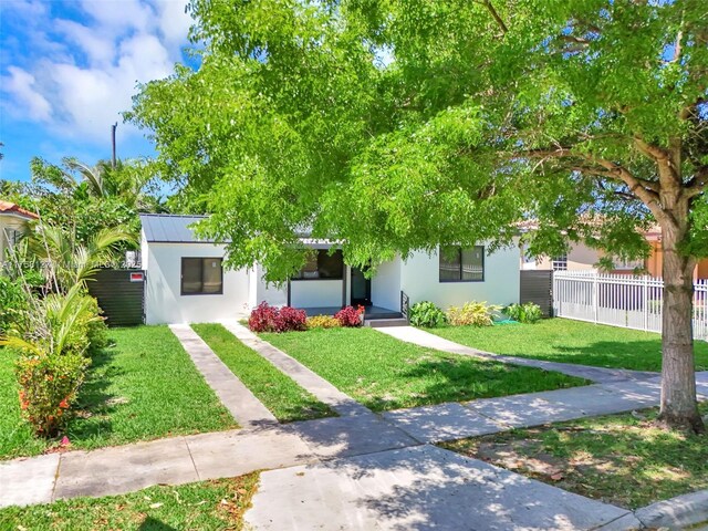 2261 SW 26th St, Miami, FL 33133 - view of property hidden behind natural elements with stucco siding, metal roof, and a standing seam roof