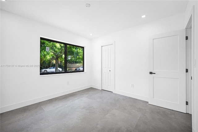 2261 SW 26th St, Miami, FL 33133 - unfurnished bedroom featuring baseboards, concrete flooring, recessed lighting, and a closet