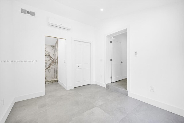 2261 SW 26th St, Miami, FL 33133 - unfurnished bedroom with a wall mounted air conditioner, baseboards, and recessed lighting