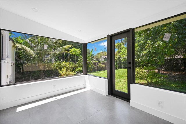 2261 SW 26th St, Miami, FL 33133 - unfurnished sunroom featuring tile patterned flooring and vaulted ceiling