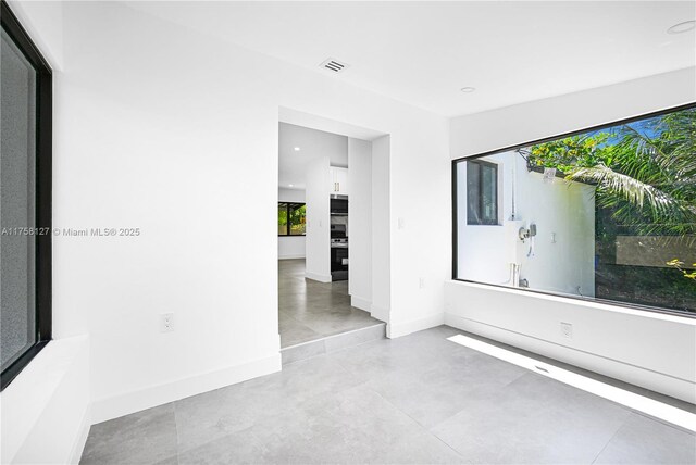 2261 SW 26th St, Miami, FL 33133 - empty room with baseboards, recessed lighting, and concrete flooring