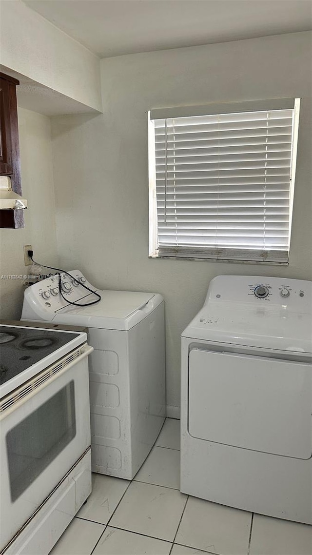 clothes washing area featuring laundry area and washer and clothes dryer