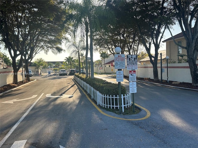 view of road featuring a gated entry and traffic signs