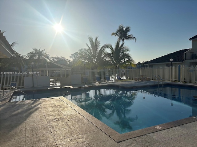 community pool featuring a patio and fence