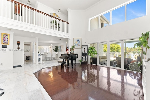 interior space with french doors, baseboards, marble finish floor, and ornamental molding