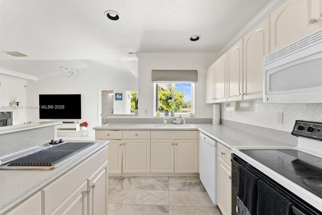 kitchen featuring a sink, a textured ceiling, white cabinetry, white appliances, and light countertops