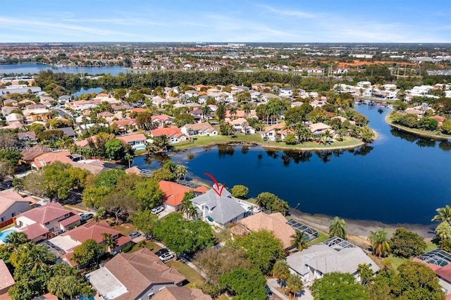 birds eye view of property featuring a residential view and a water view