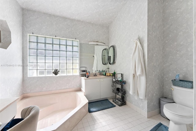 full bathroom with tile patterned floors, toilet, baseboards, a bath, and vanity