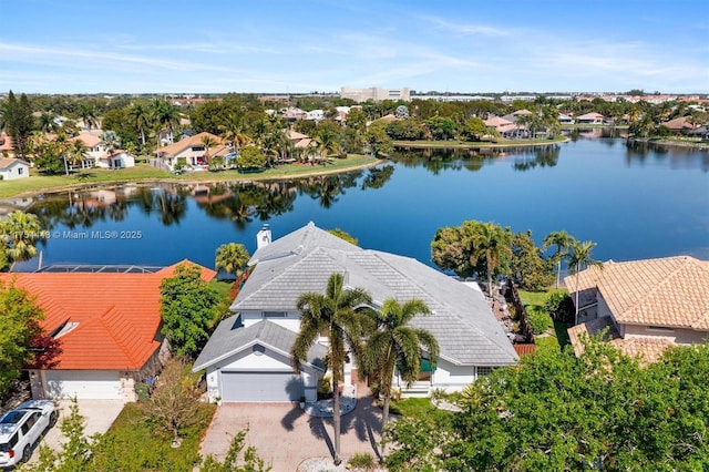 drone / aerial view featuring a residential view and a water view