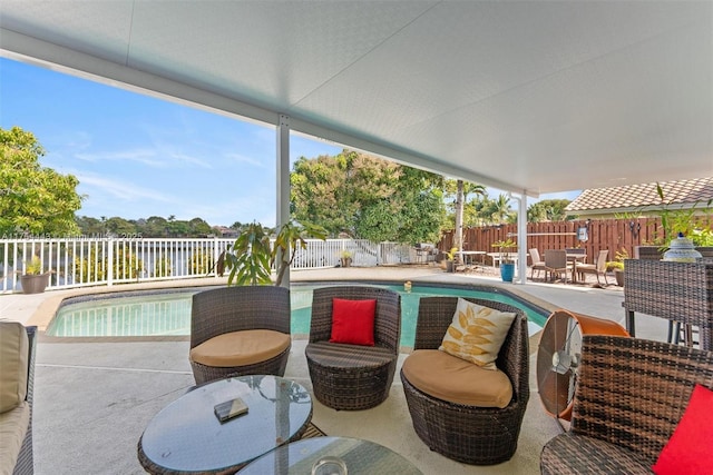 view of swimming pool with outdoor dining space, a patio area, a fenced in pool, and a fenced backyard