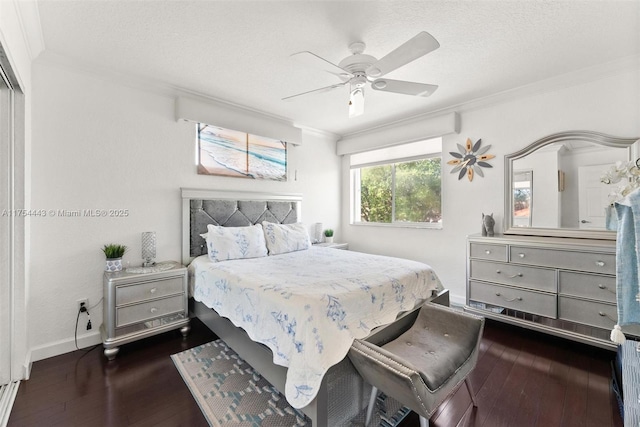 bedroom featuring a ceiling fan, hardwood / wood-style flooring, a textured ceiling, crown molding, and baseboards