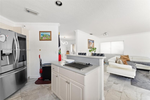 kitchen with visible vents, open floor plan, ornamental molding, marble finish floor, and stainless steel appliances