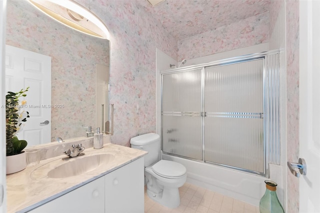 full bathroom with combined bath / shower with glass door, toilet, wallpapered walls, and vanity