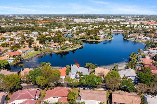 drone / aerial view featuring a residential view and a water view