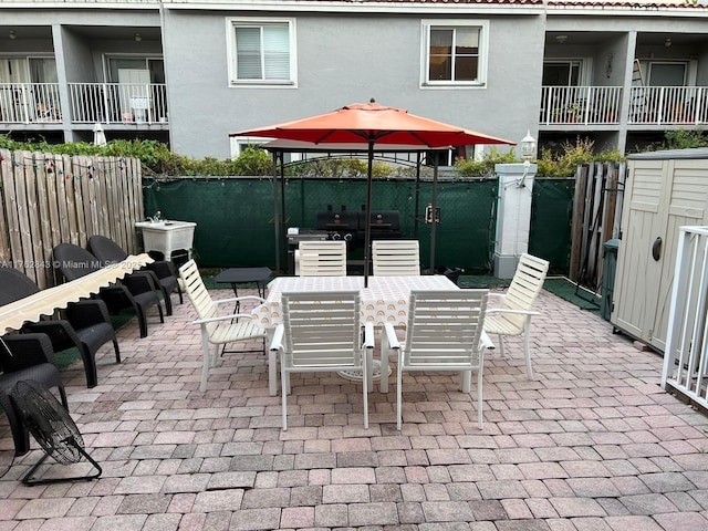 view of patio featuring outdoor dining area, area for grilling, and a fenced backyard