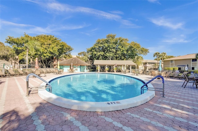 pool featuring a patio area and fence