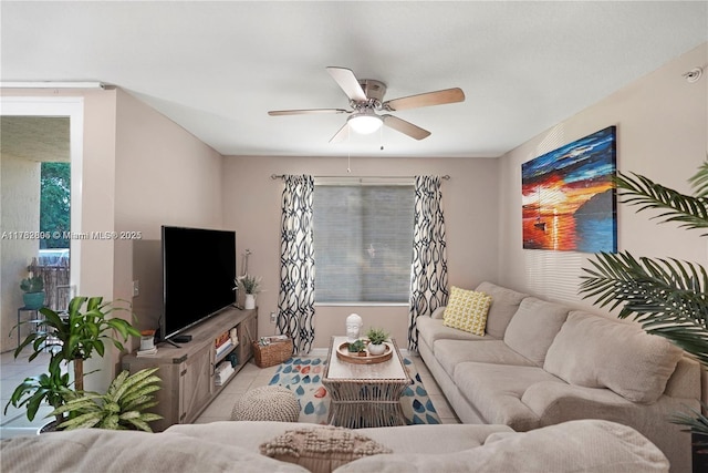 living area with tile patterned floors and ceiling fan