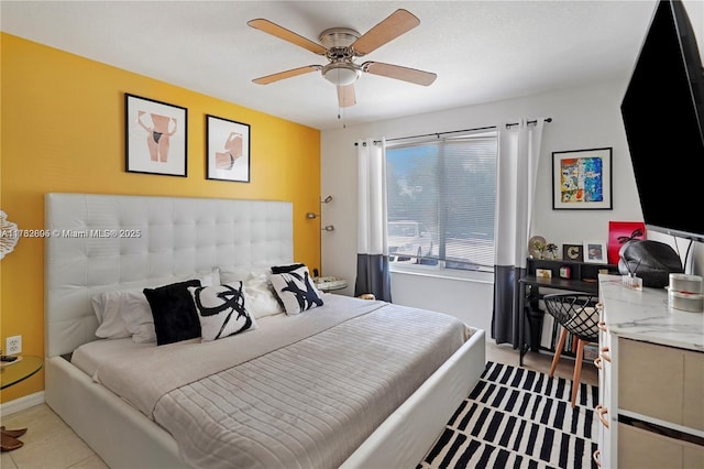 tiled bedroom with baseboards and ceiling fan