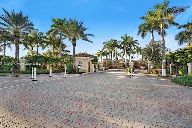 view of road featuring curbs and a gated entry