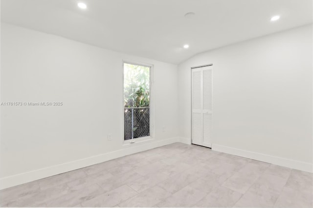 unfurnished room featuring baseboards, recessed lighting, and lofted ceiling