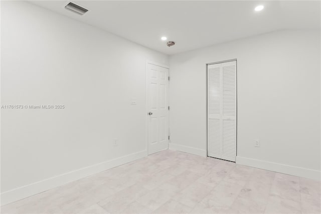 unfurnished bedroom with baseboards, visible vents, and recessed lighting